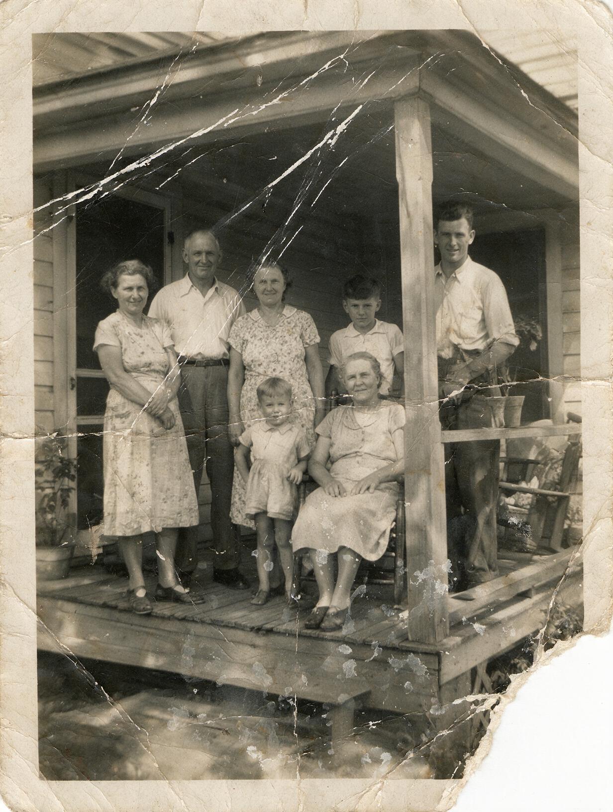 An old scanned print with scratches and fading before AI restoration